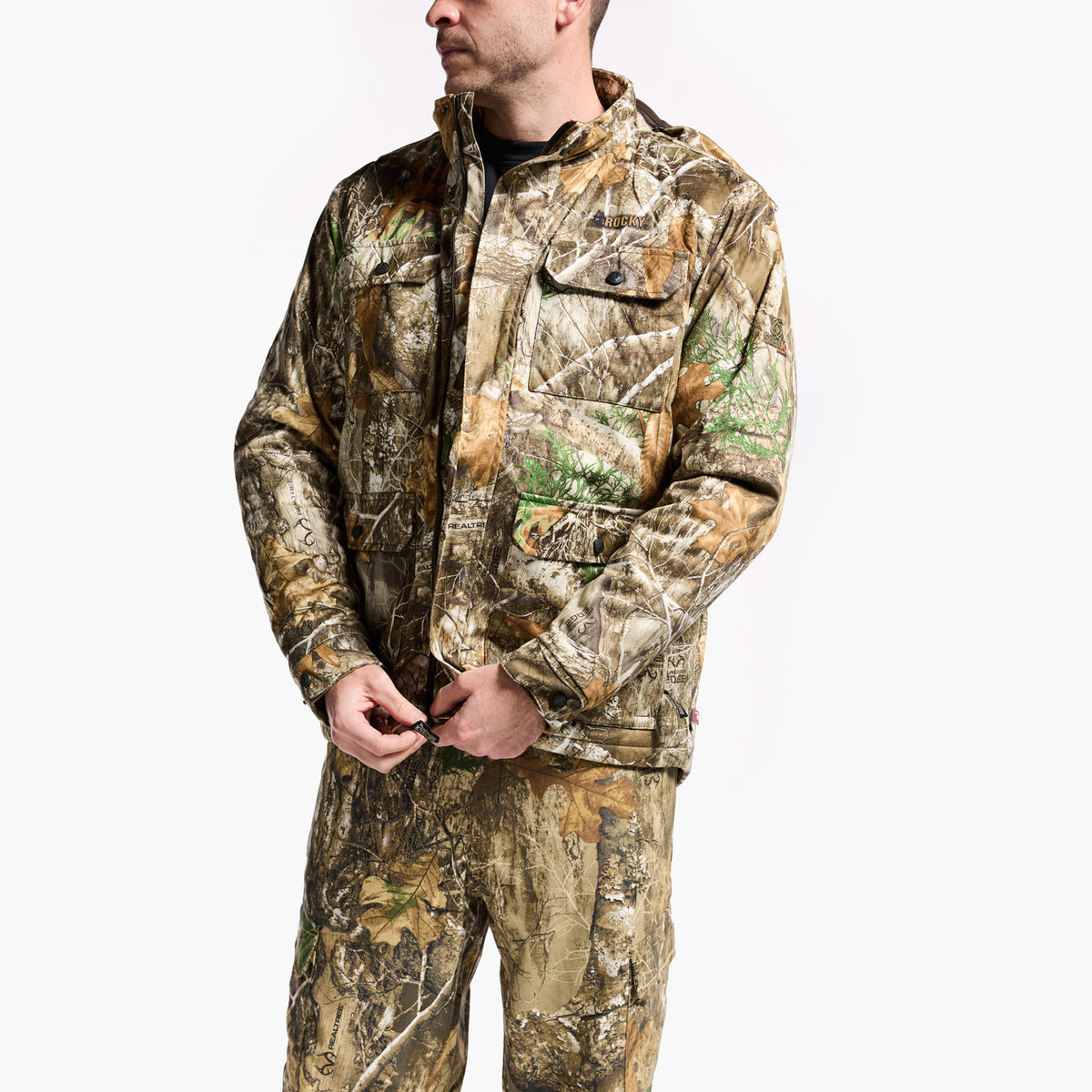 Person wearing a camouflage hunting outfit on a white background