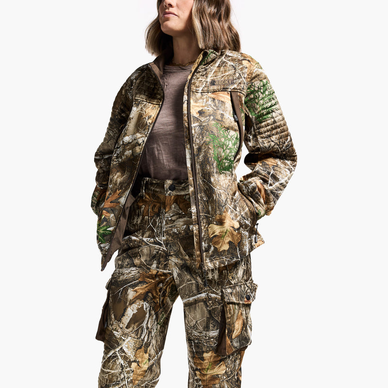 Person wearing a full camouflage hunting outfit on a white background