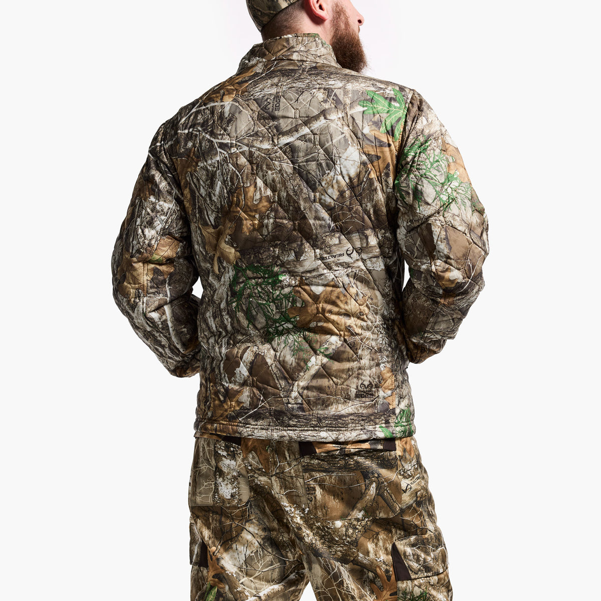 Person wearing a full camouflage outfit on a white background