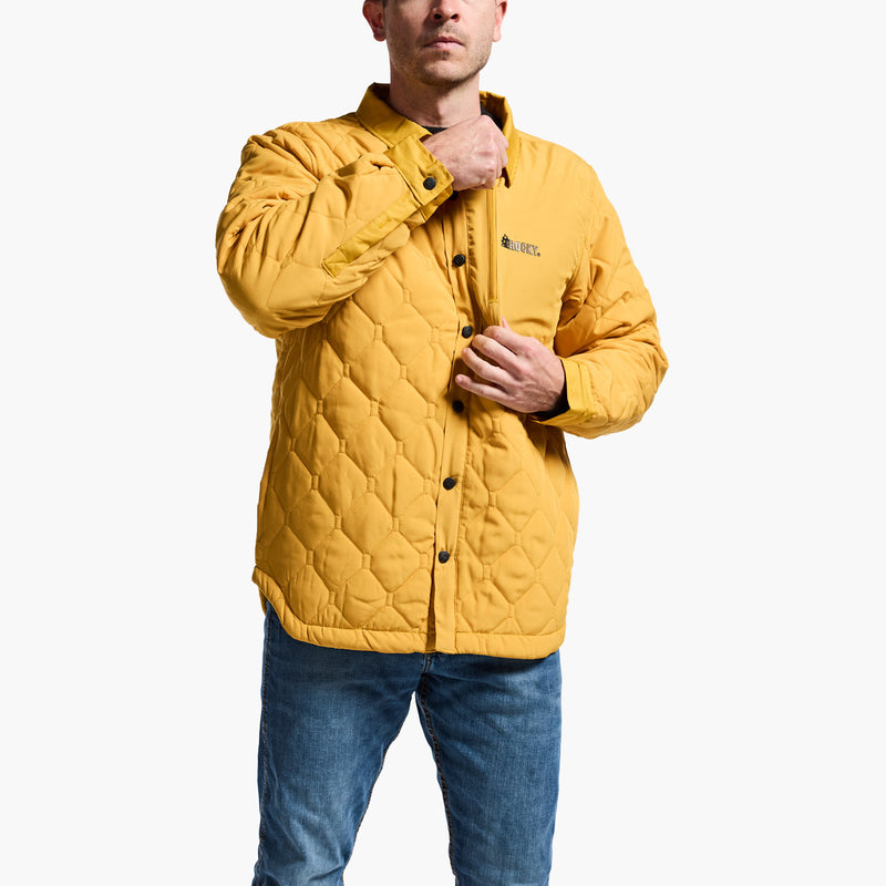 Person wearing a yellow quilted jacket on a white background