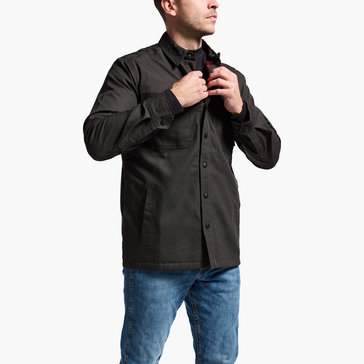 Man wearing a black jacket and blue jeans on a white background