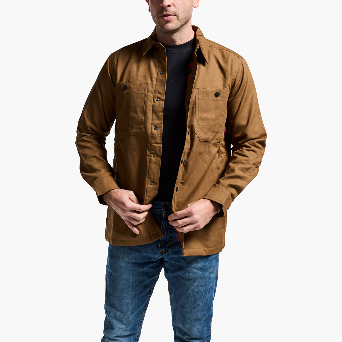 Man wearing a brown jacket and blue jeans on a white background