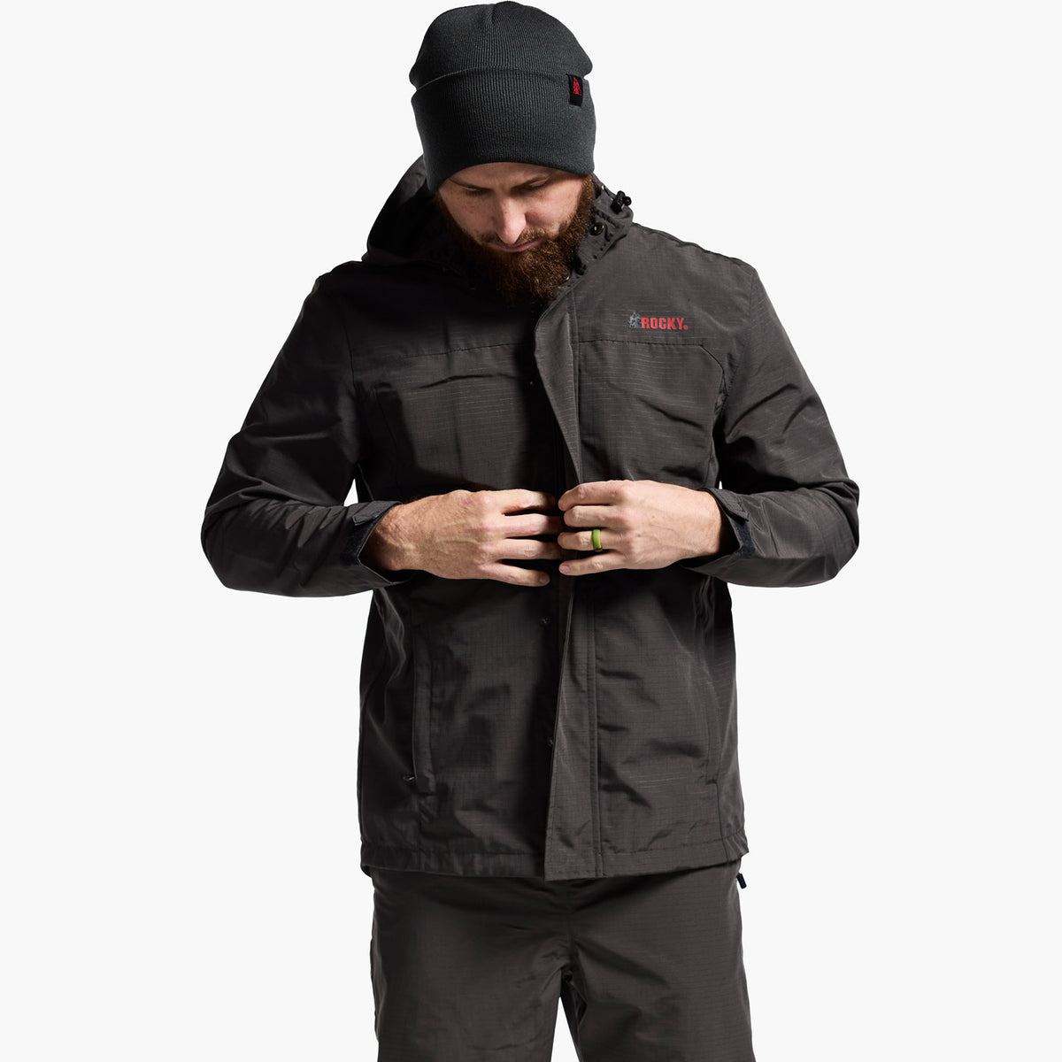 Man wearing a black jacket with a brand logo on a white background