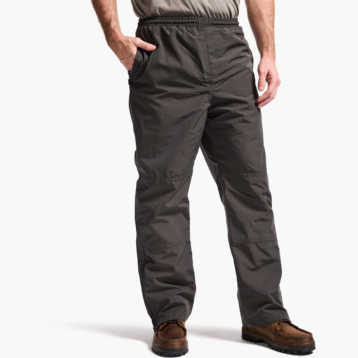 Person wearing dark gray pants on a white background